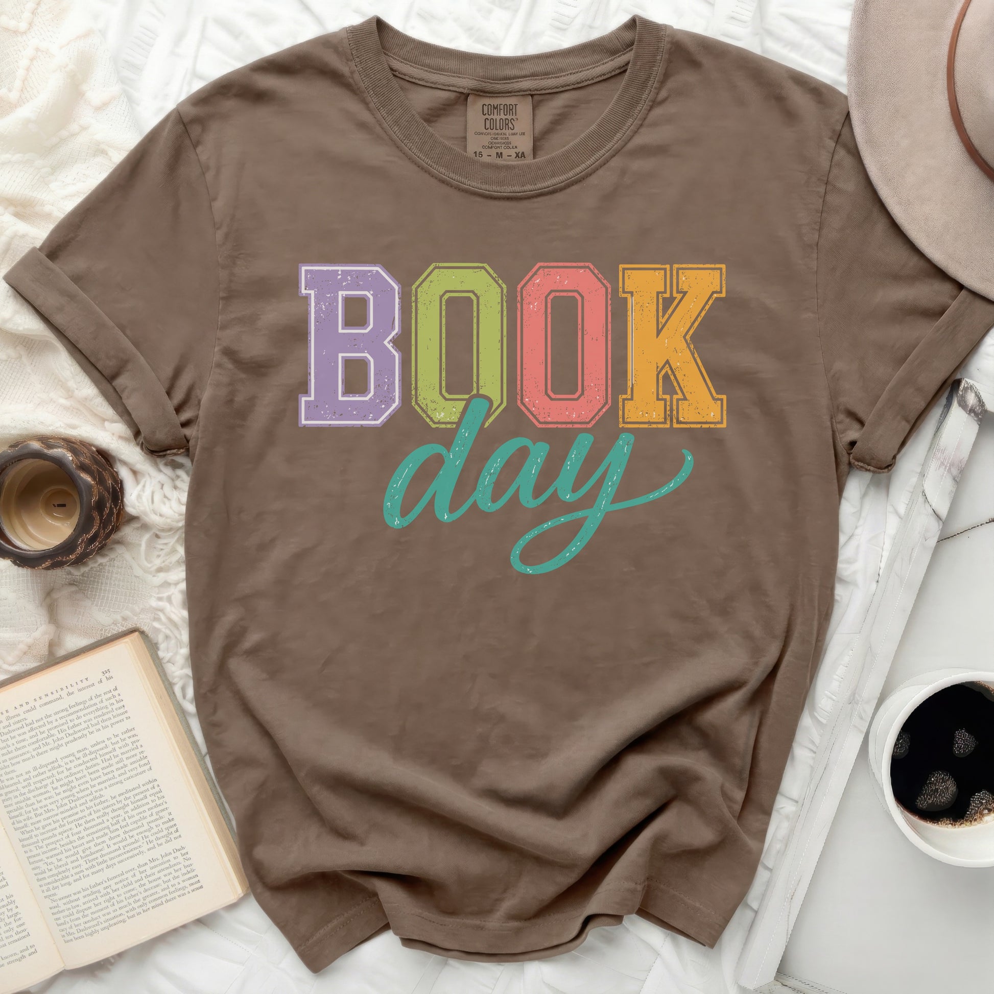 Brown t-shirt with "BOOK day" text in colorful block letters.