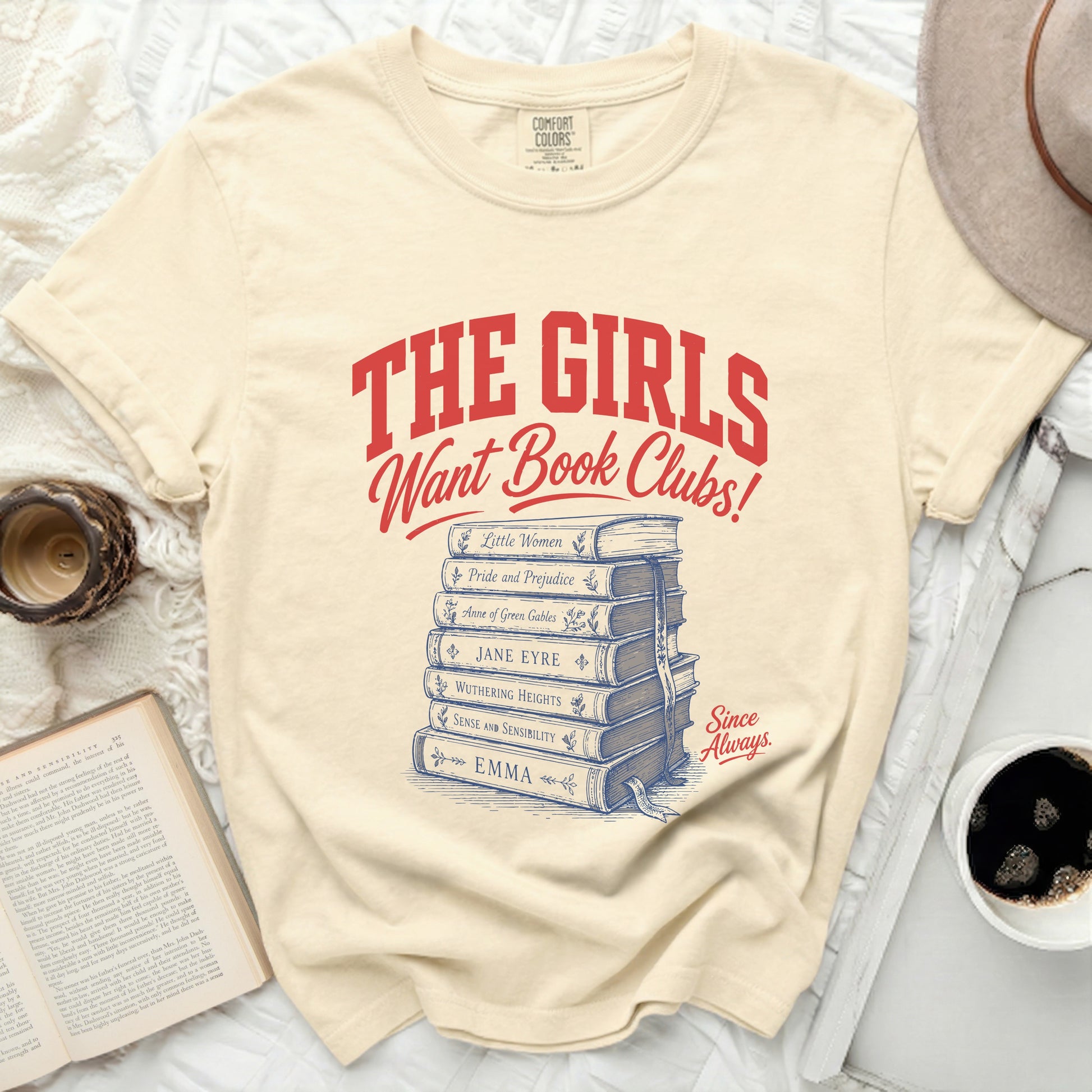 Cream t-shirt with "The Girls Want Book Clubs!" and book titles.