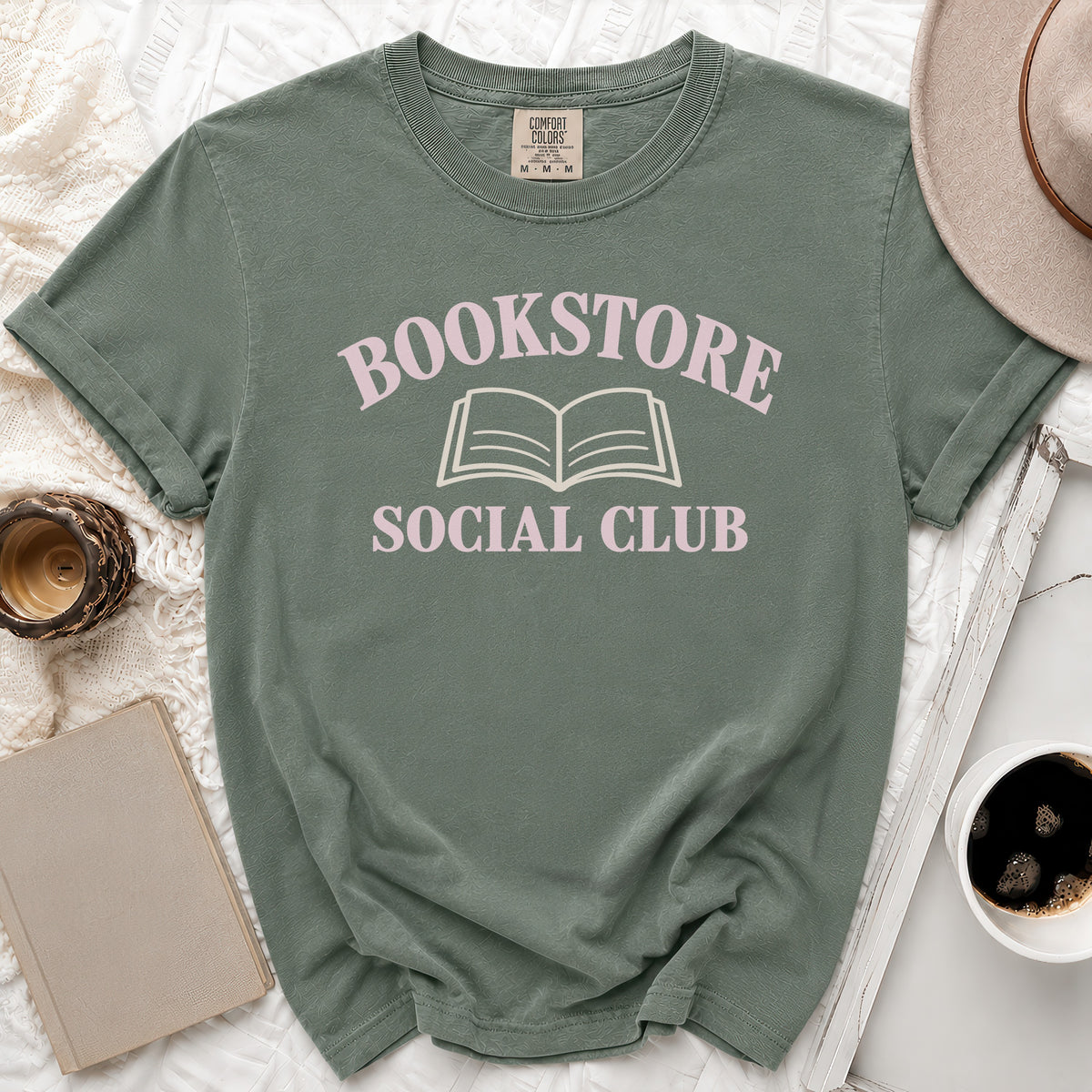 Green t-shirt with "Bookstore Social Club" text and open book graphic.