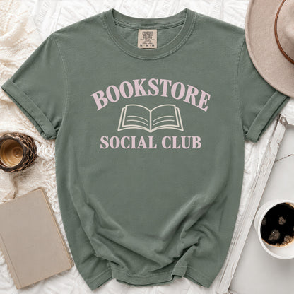Green t-shirt with "Bookstore Social Club" text and open book graphic.