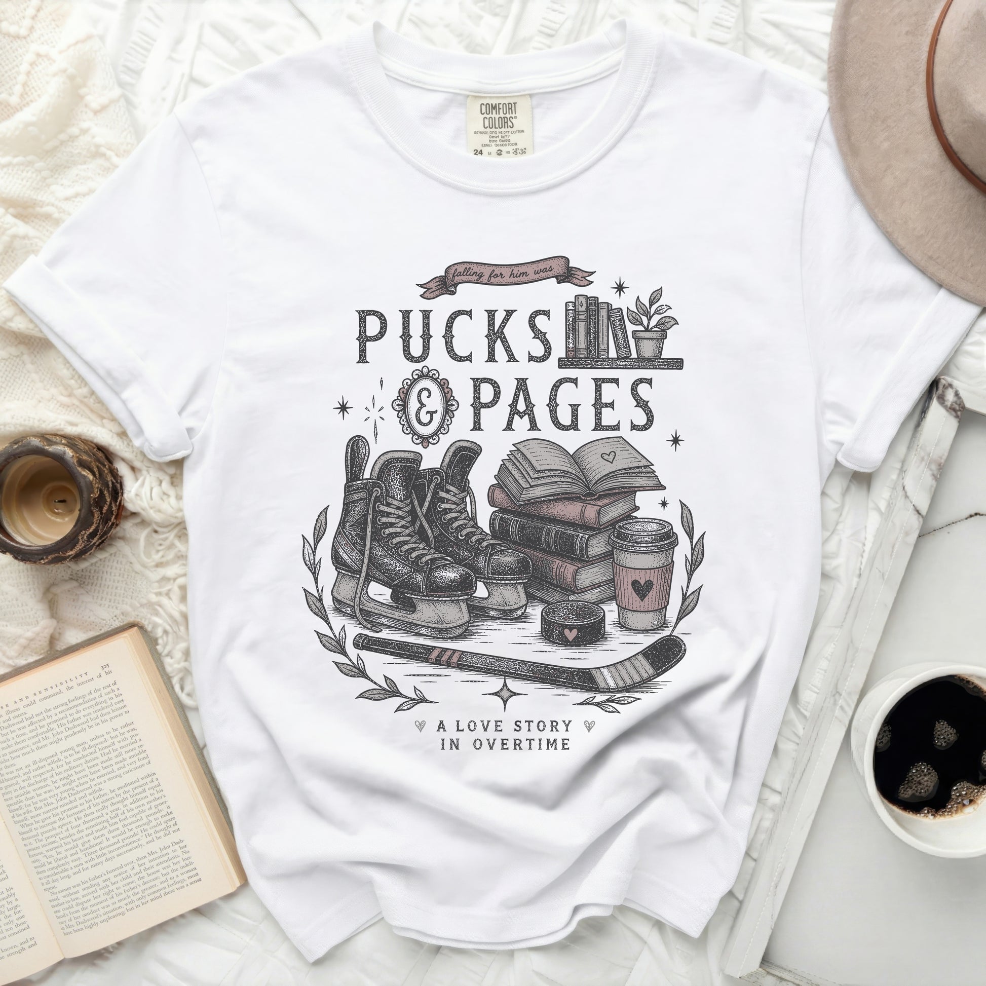 T-shirt with "Pucks & Pages" and hockey, book, coffee, and heart graphics.