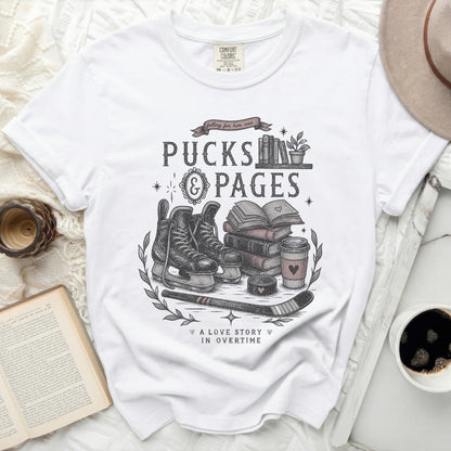 T-shirt with "Pucks & Pages" and hockey, book, coffee, and heart graphics.