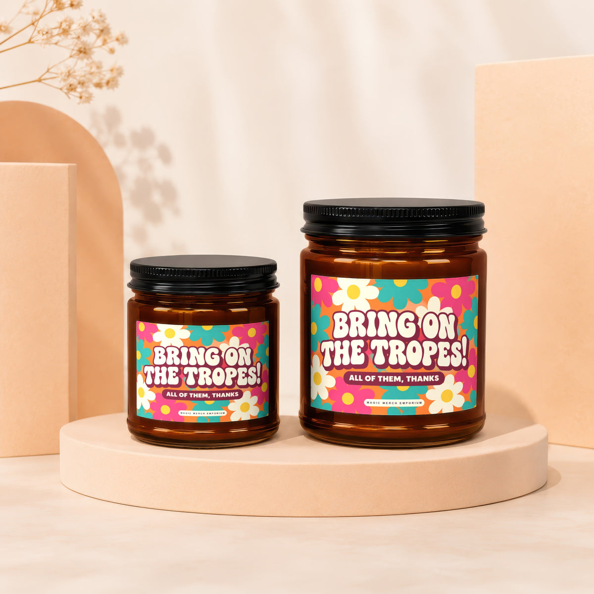 Two amber jars with black lids, featuring floral labels that read "BRING ON THE TROPES!".