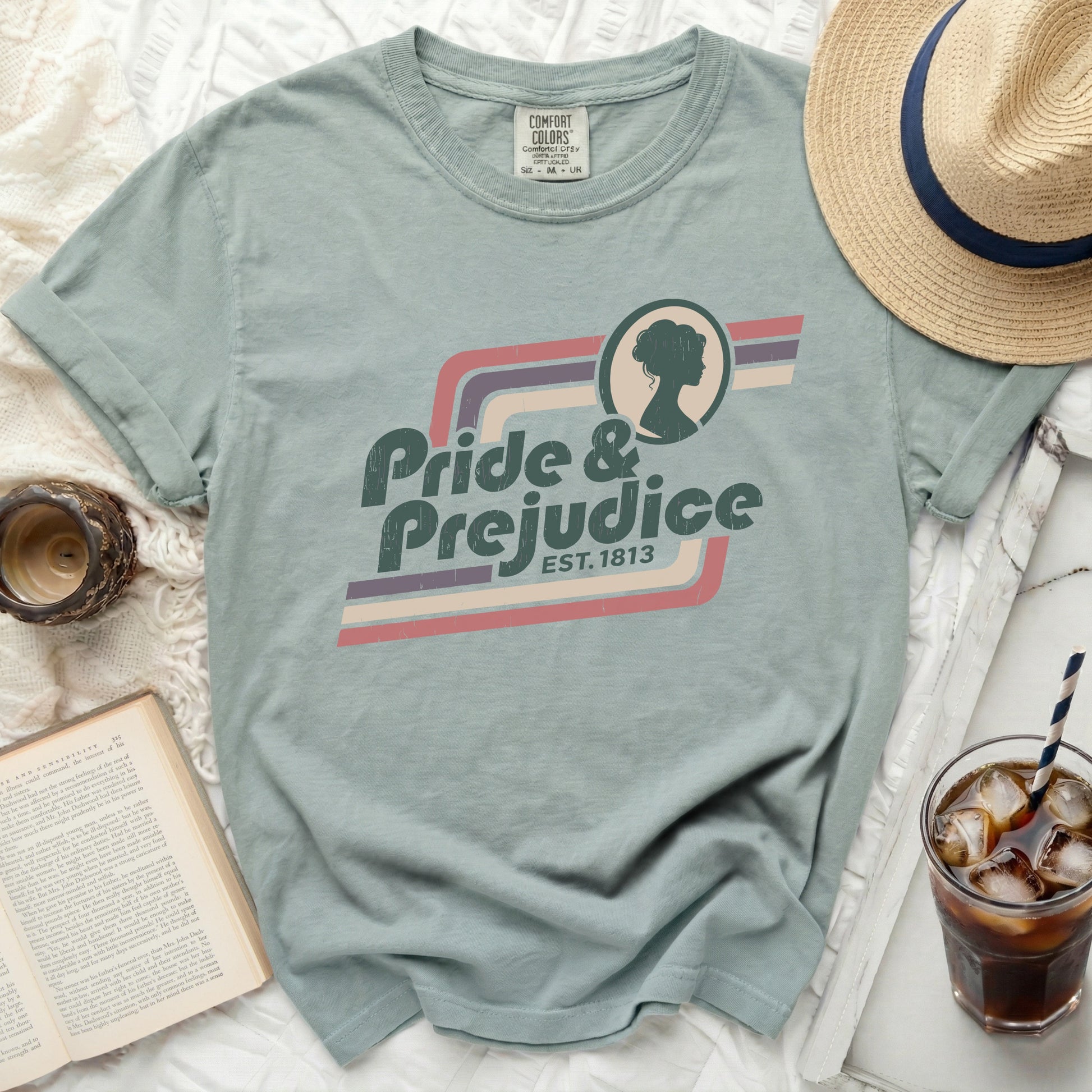 Green t-shirt with "Pride & Prejudice EST. 1813" graphic and silhouette