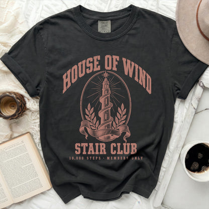 Charcoal t-shirt featuring pink graphic text reading HOUSE OF WIND STAIR CLUB with a spiraling tower design.