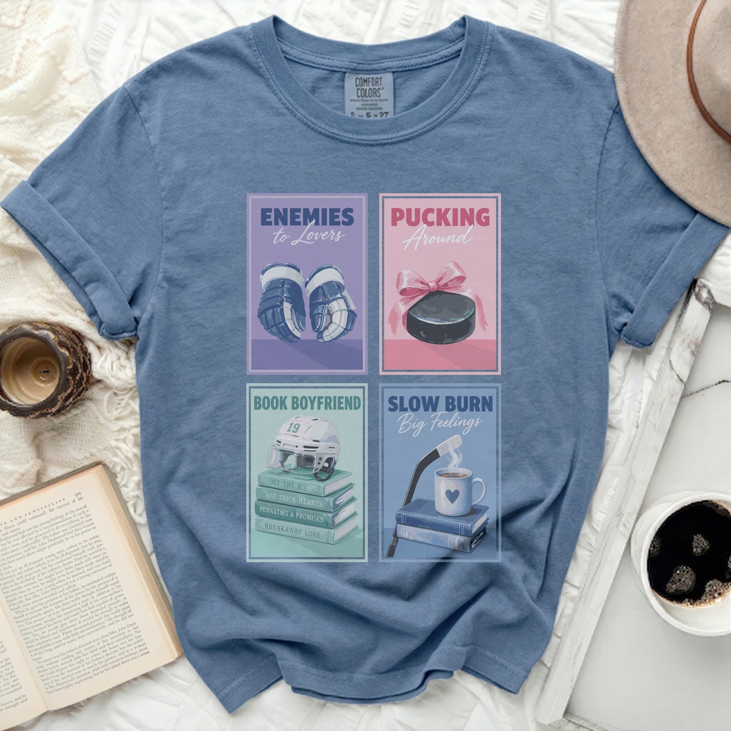 Blue t-shirt with four vintage-style graphics about romance and hockey.