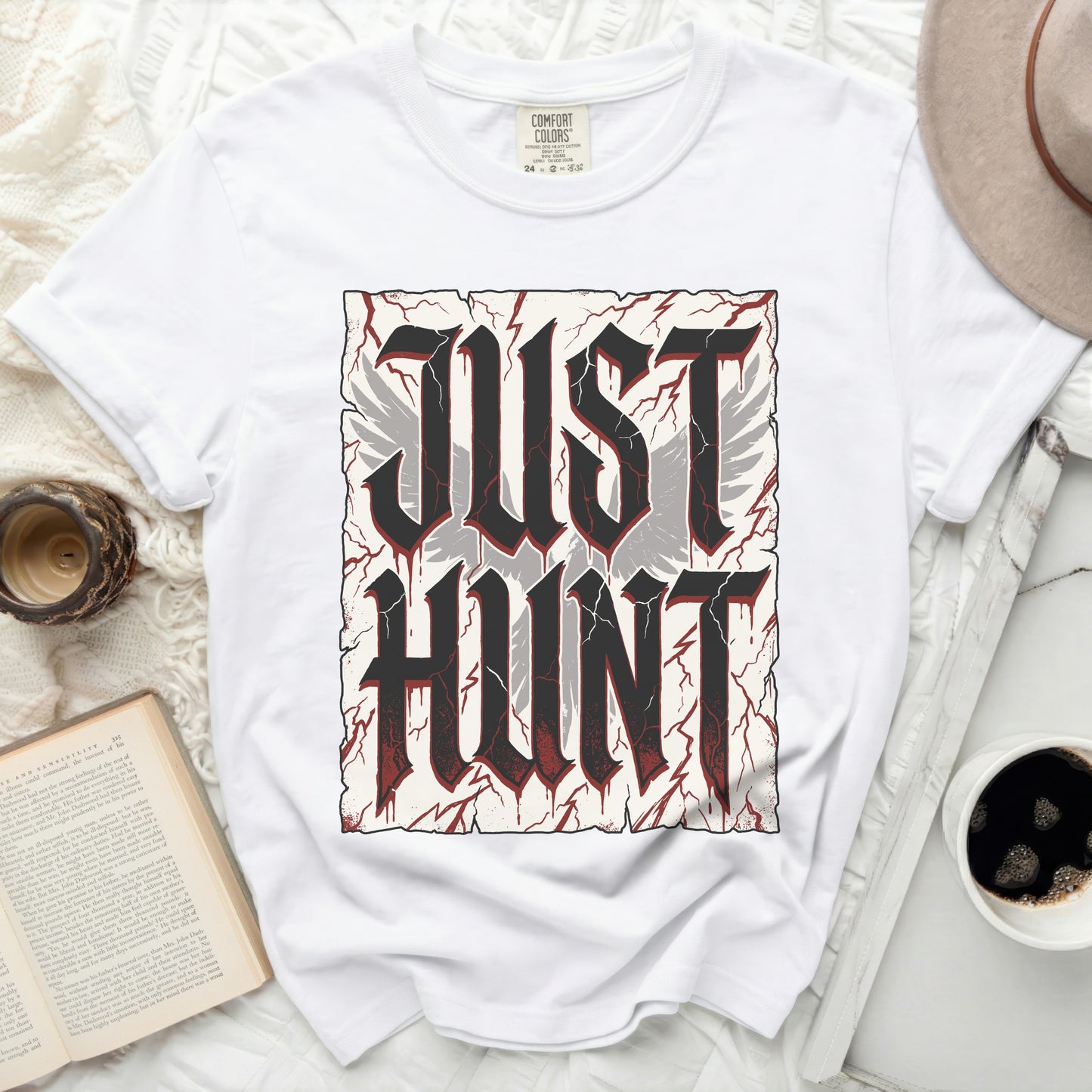 White t-shirt with gothic "JUST HUNT" text and winged design.