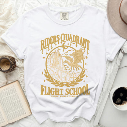 White t-shirt with gold graphic of castle, dragon, and "Riders Quadrant Flight School".