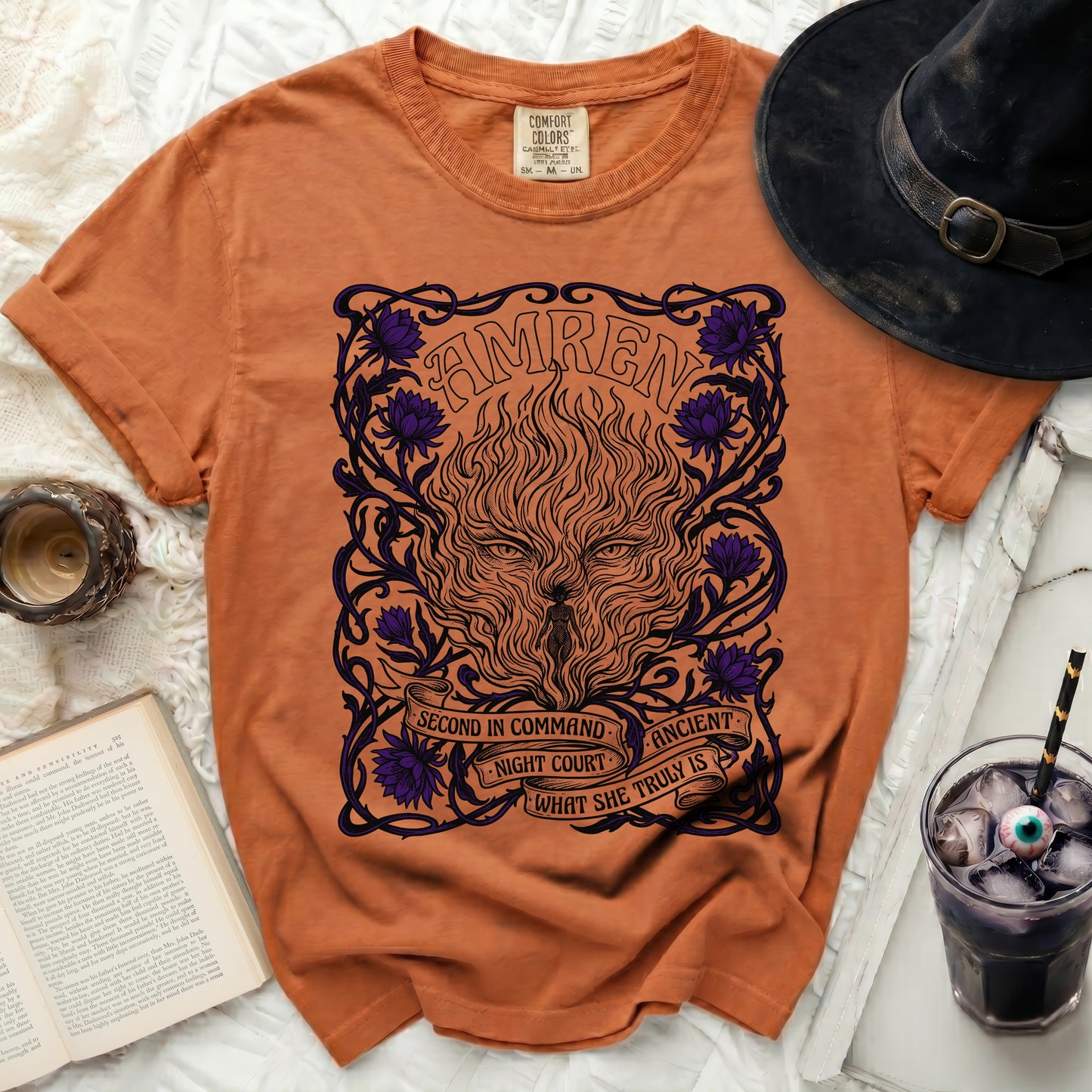 Orange t-shirt with a black and purple graphic of a fiery wolf and floral design.