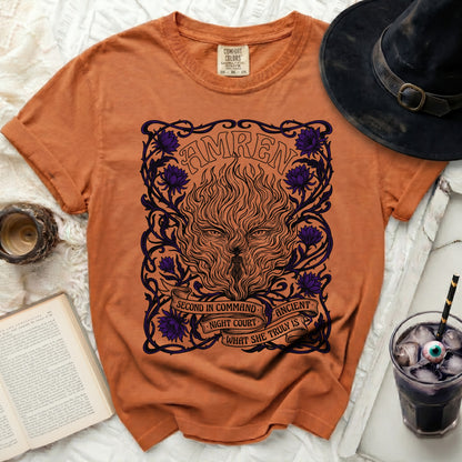 Orange t-shirt with a black and purple graphic of a fiery wolf and floral design.