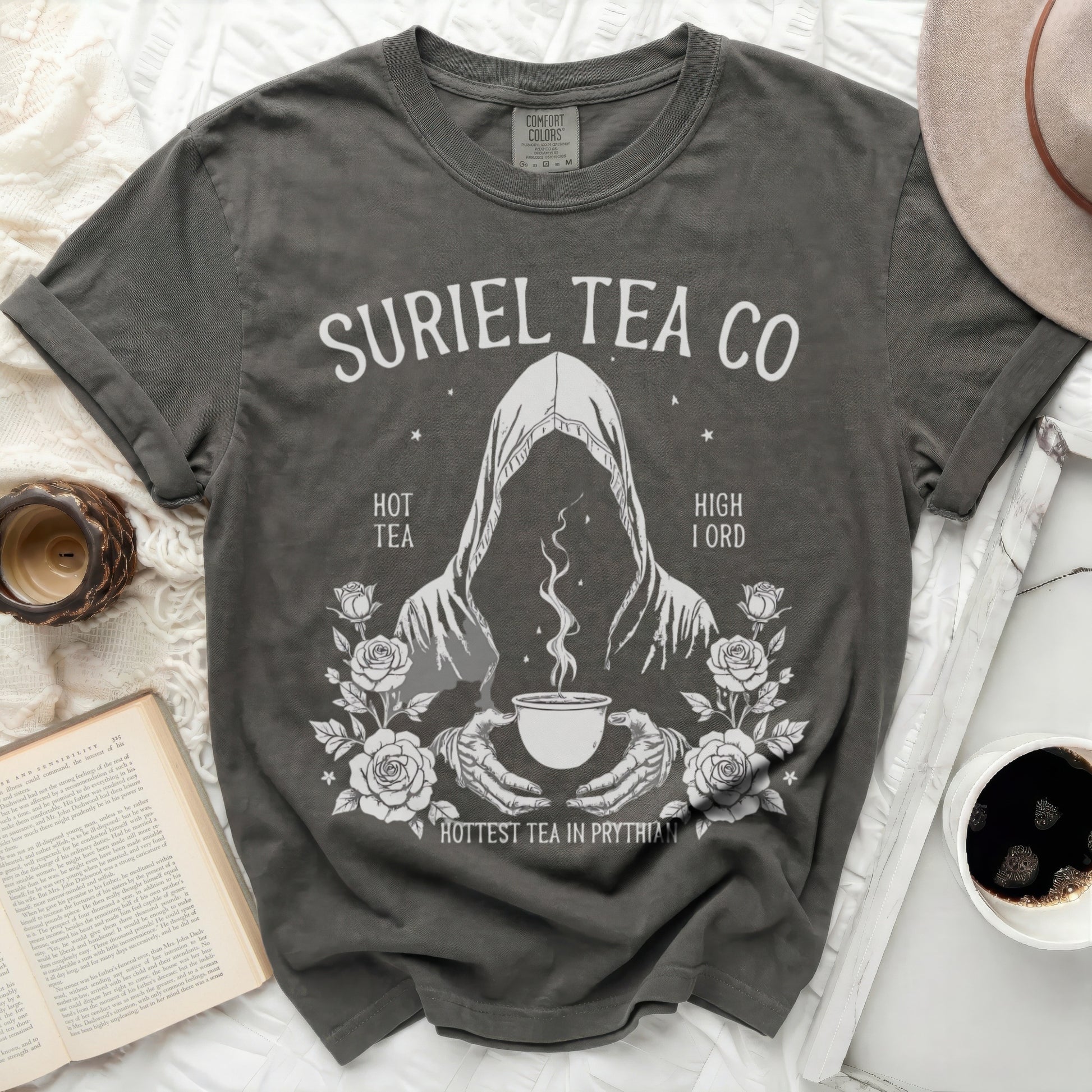 Suriel Tea Co graphic t-shirt with a hooded figure holding a teacup.