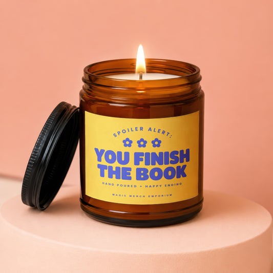 Amber jar candle with yellow label reading "You Finish The Book".