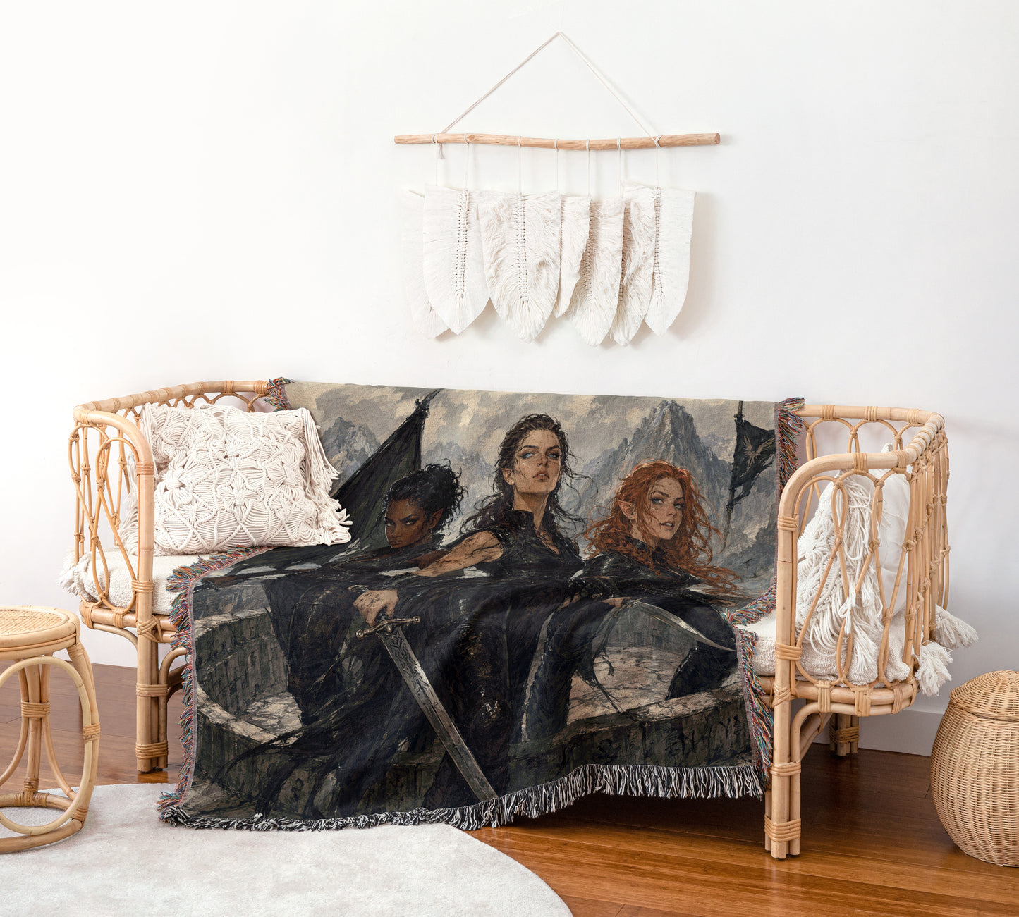 a cozy living room setting with a woven bench and a woven side table. On the bench, there is a large woven blanket with a painting of three women, and a small woven basket. The wall behind the bench has a hanging decoration made of white feathers.