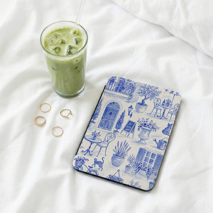 Tablet case with blue and white French garden scene and a glass of iced matcha.