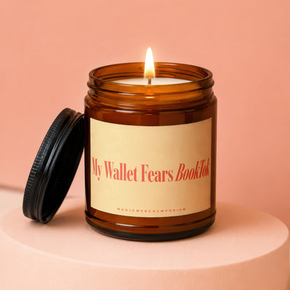Amber jar candle with lit wick and lid askew, "My Wallet Fears BookTok" text.