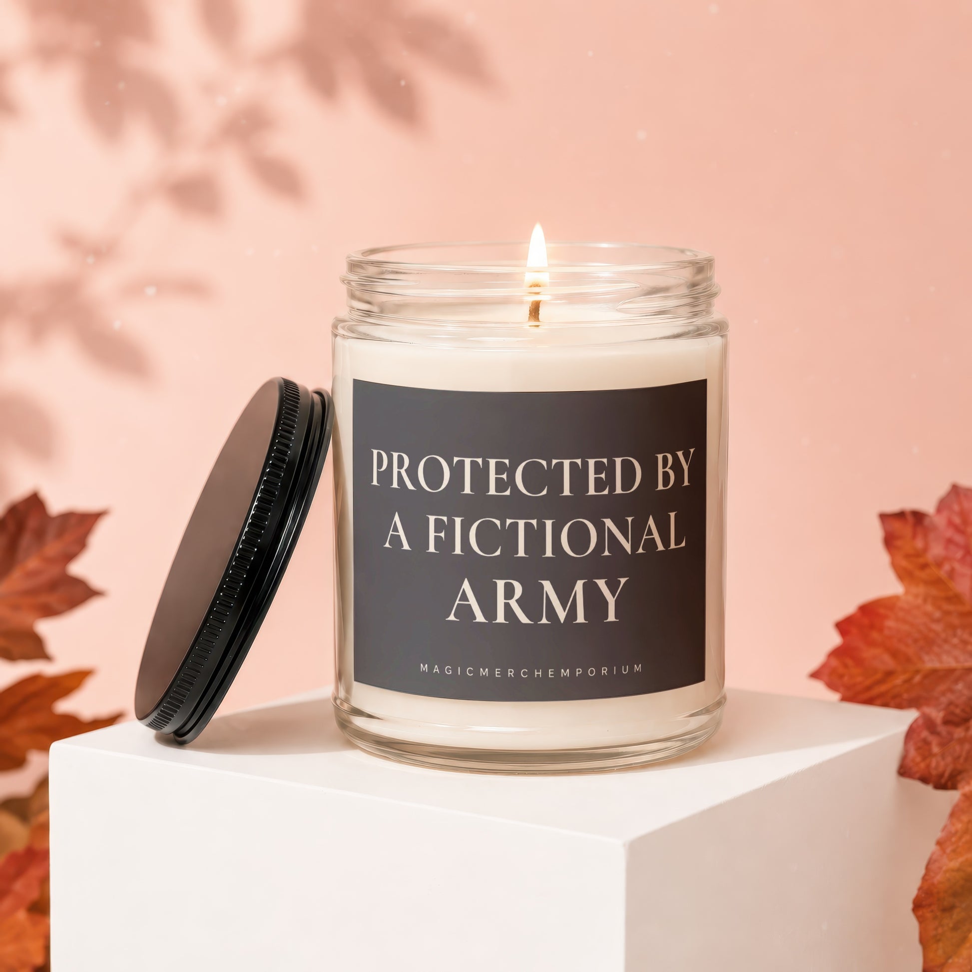 Glass candle with a burning wick and text "Protected by a Fictional Army".