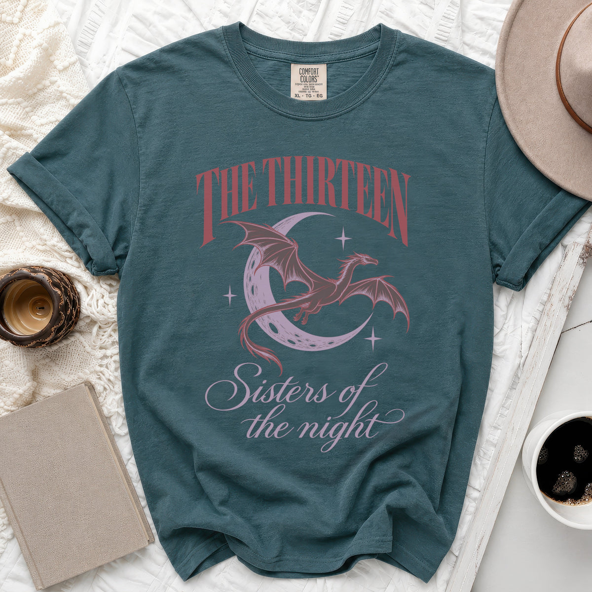 Teal t-shirt with red text "The Thirteen" and dragon on moon graphic.