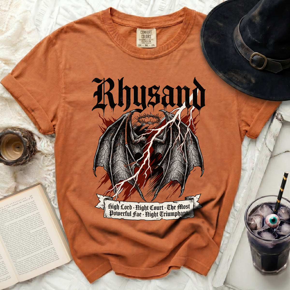 Orange t-shirt with Rhysand, wings, crown, and lightning bolt graphic.