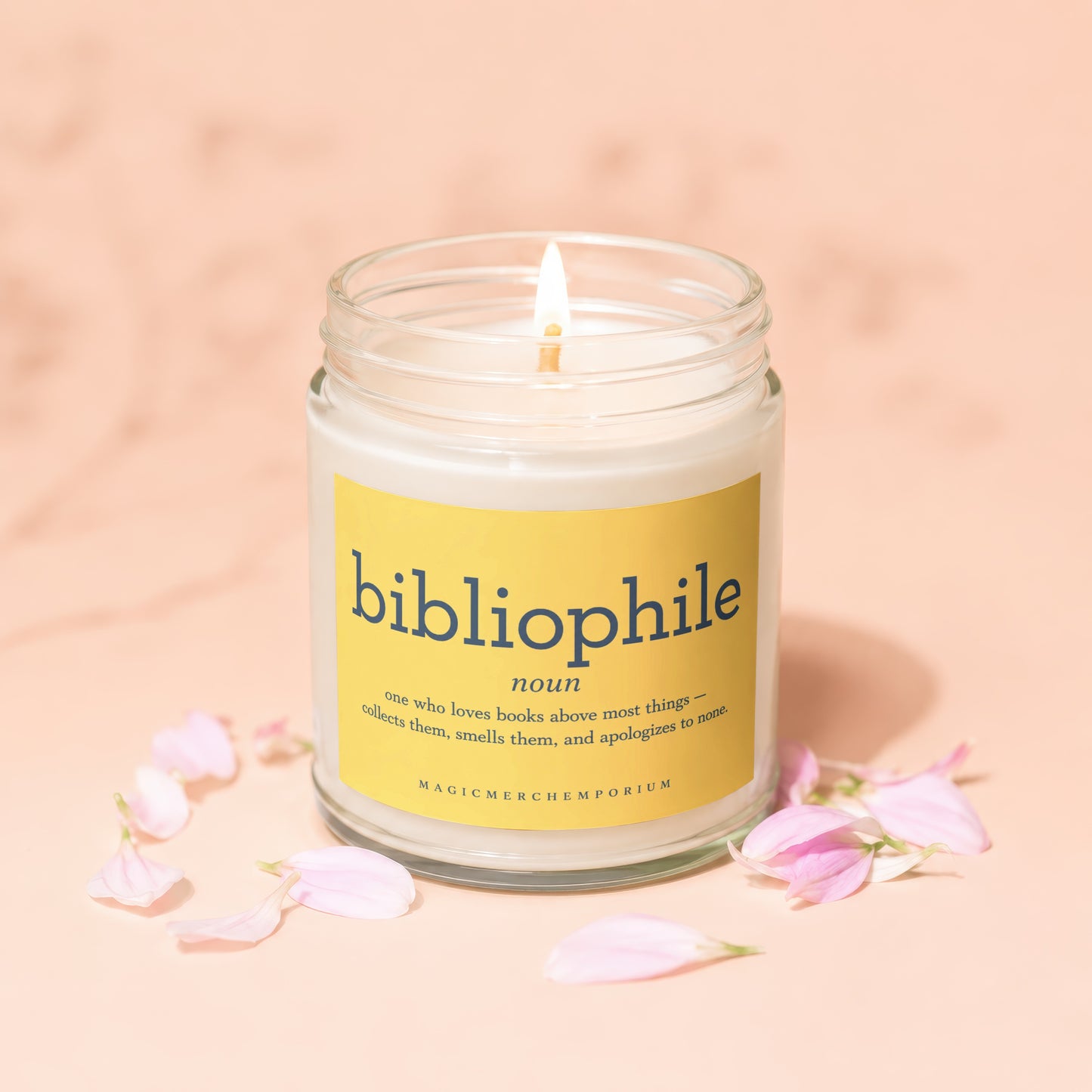 Scented candle with "bibliophile" definition on a yellow label.