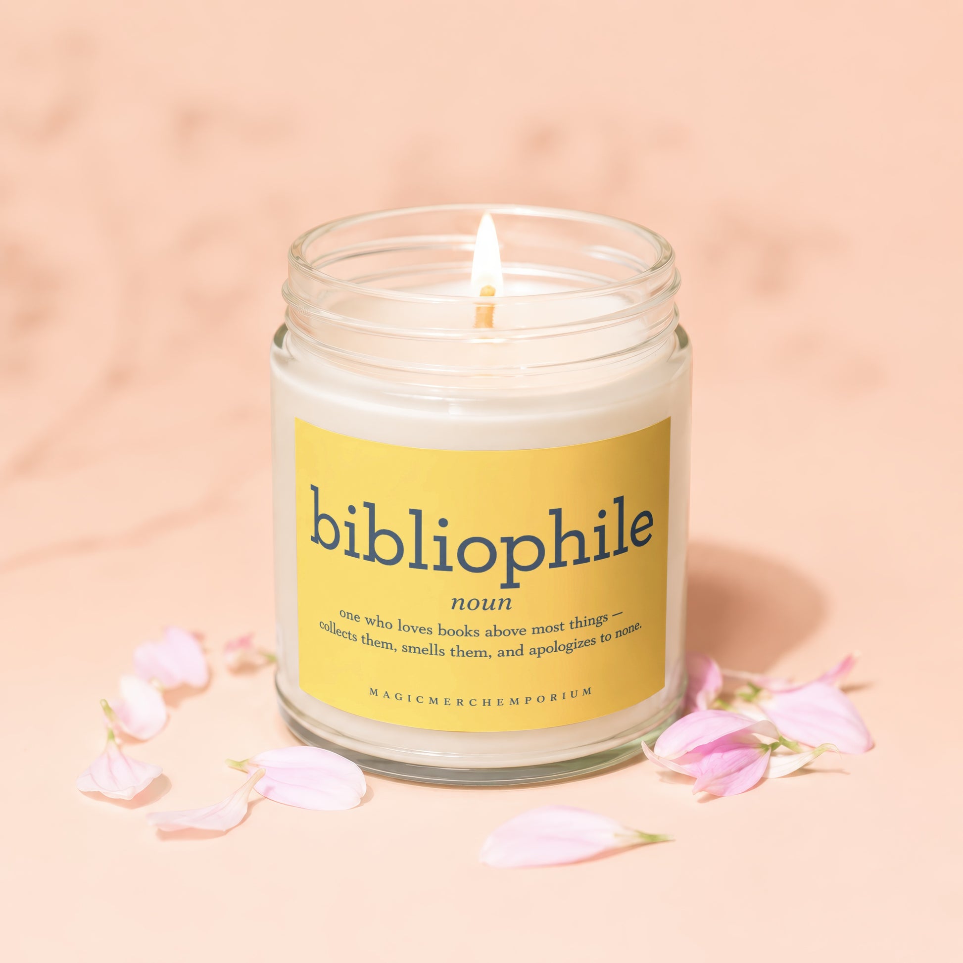 Scented candle with "bibliophile" definition on a yellow label.