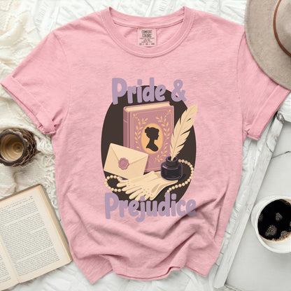 Pink t-shirt with "Pride & Prejudice" graphic featuring book, quill, and gloves.
