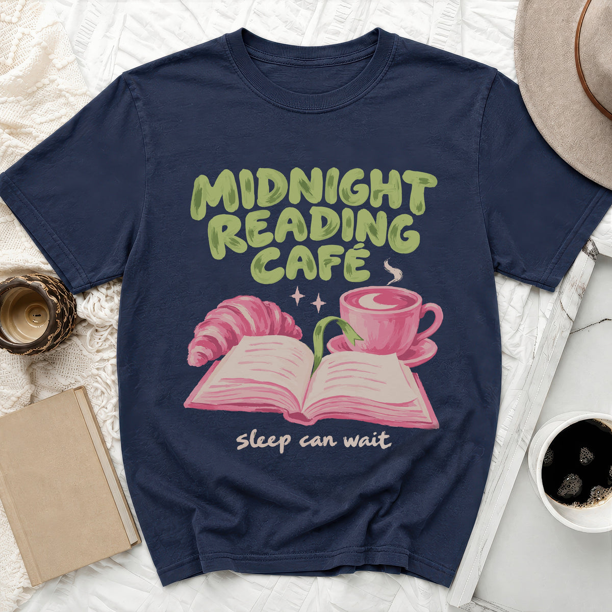 Navy t-shirt with "Midnight Reading Cafe" text, croissant, book, and coffee cup graphic.