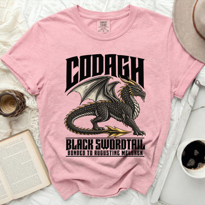 Pink t-shirt with a black dragon graphic and text "Codagh Black Swordtail".