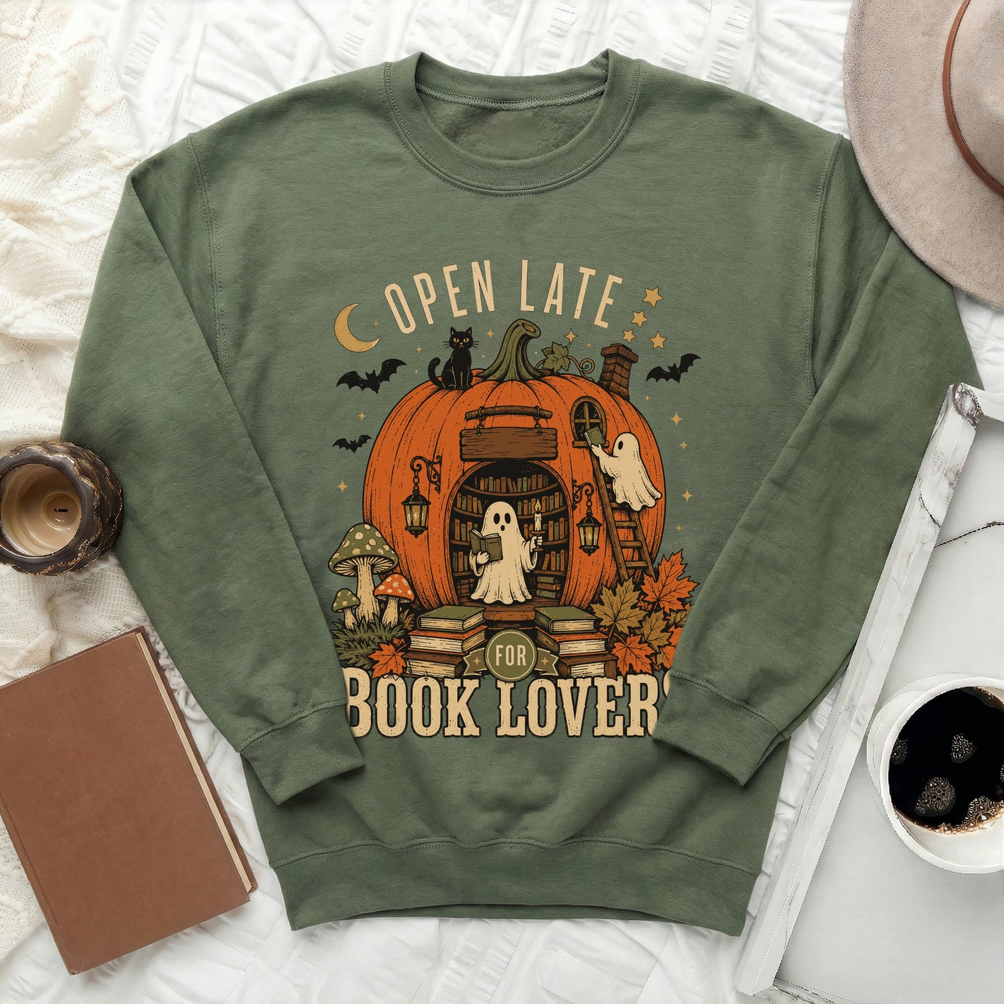 Green sweatshirt with "Open Late For Book Lovers" text and Halloween pumpkin graphic.