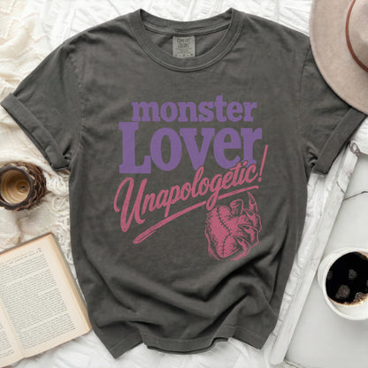 Dark gray t-shirt with purple "monster Lover" and pink "Unapologetic!" text.