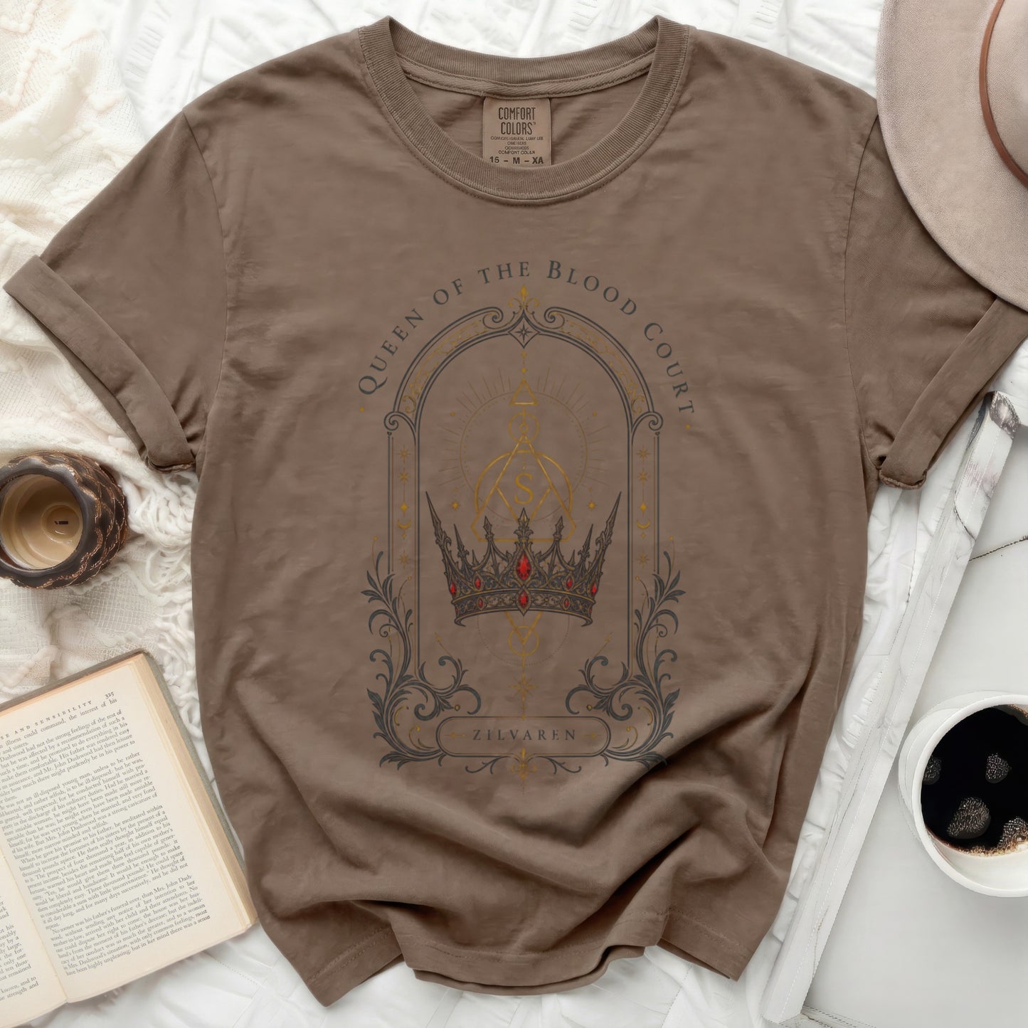 Brown t-shirt with "Queen of the Blood Court Zilvaren" crown graphic.