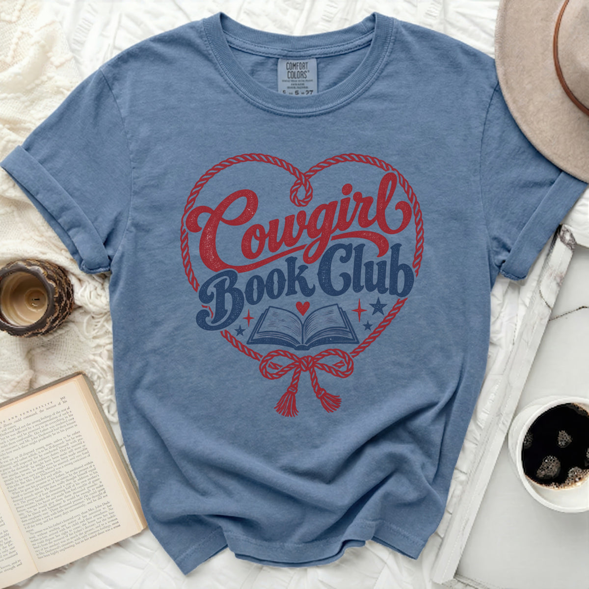 Blue t-shirt with "Cowgirl Book Club" text inside a heart shape.