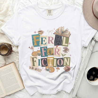 White t-shirt with "FERAL FOR FICTION" text and illustrations.
