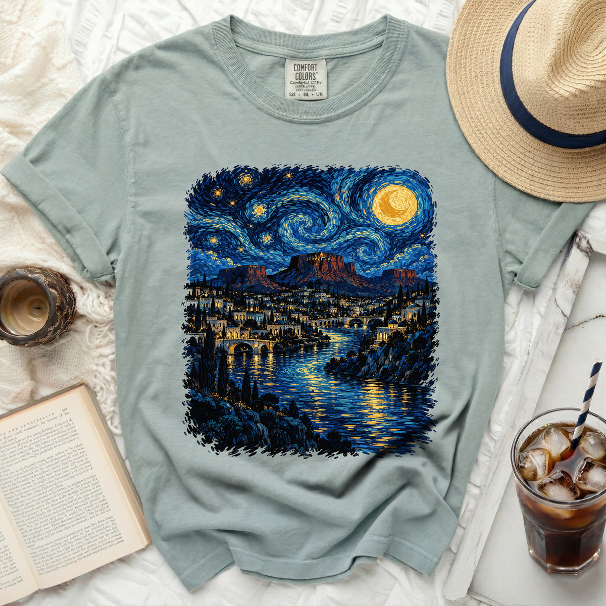 Light blue Comfort Colors t-shirt with a stylized starry night landscape print.