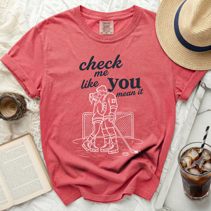Red t-shirt with "check me like you mean it" graphic and hockey couple illustration.
