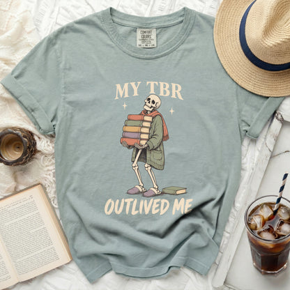 Skeleton graphic on a t-shirt with text "My TBR Outlived Me" and stacked books.