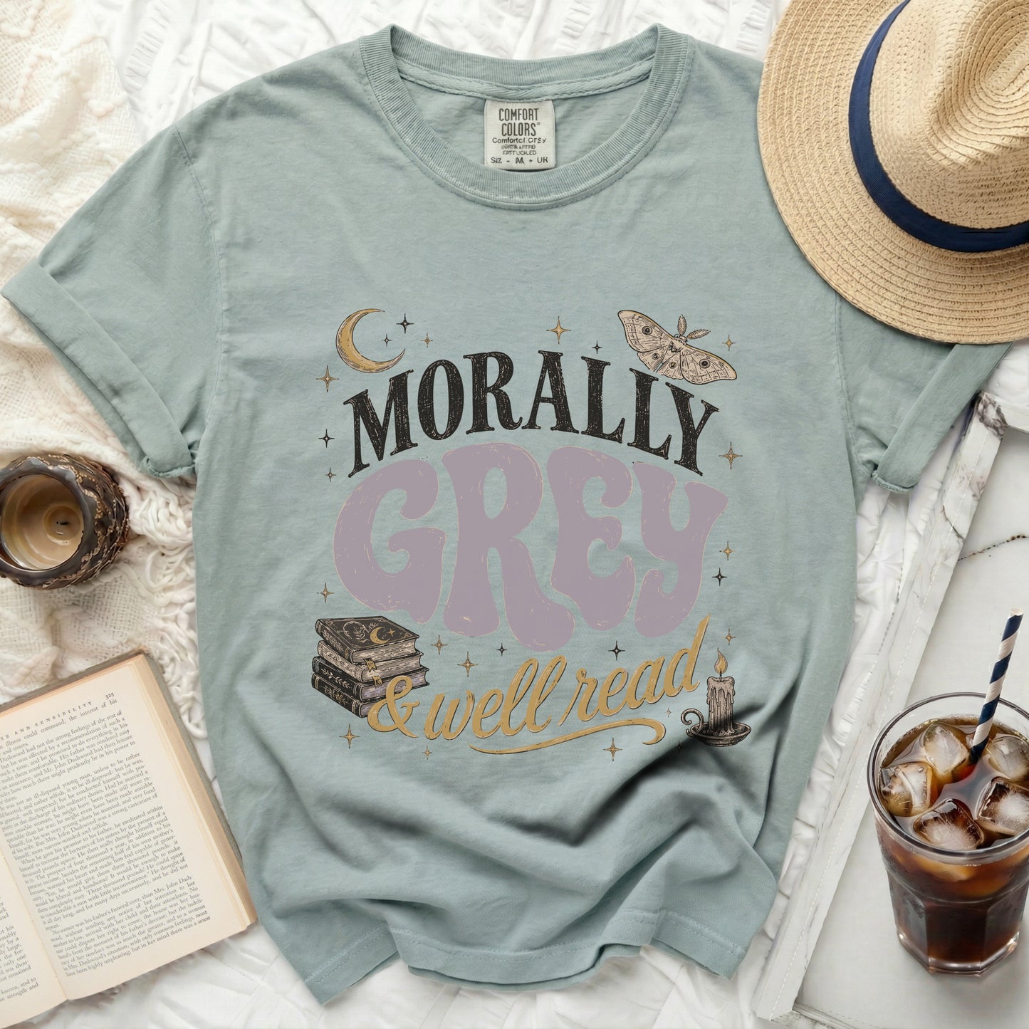 Morally Grey & Well Read text on a pale blue t-shirt with book and moth graphics.