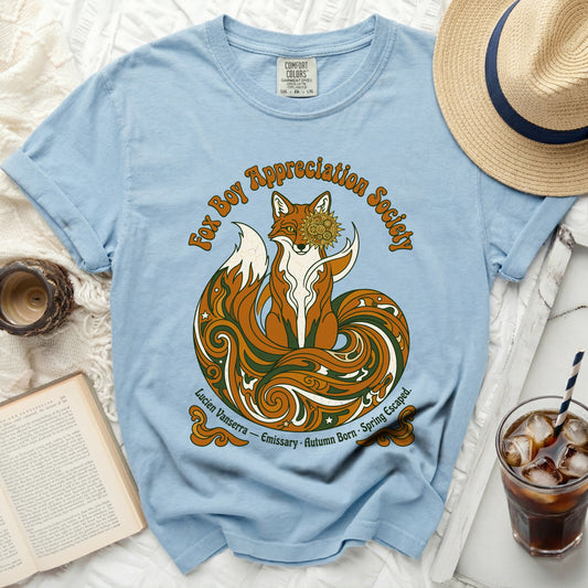 Light blue t-shirt with a stylized fox and "Fox Boy Appreciation Society" text.
