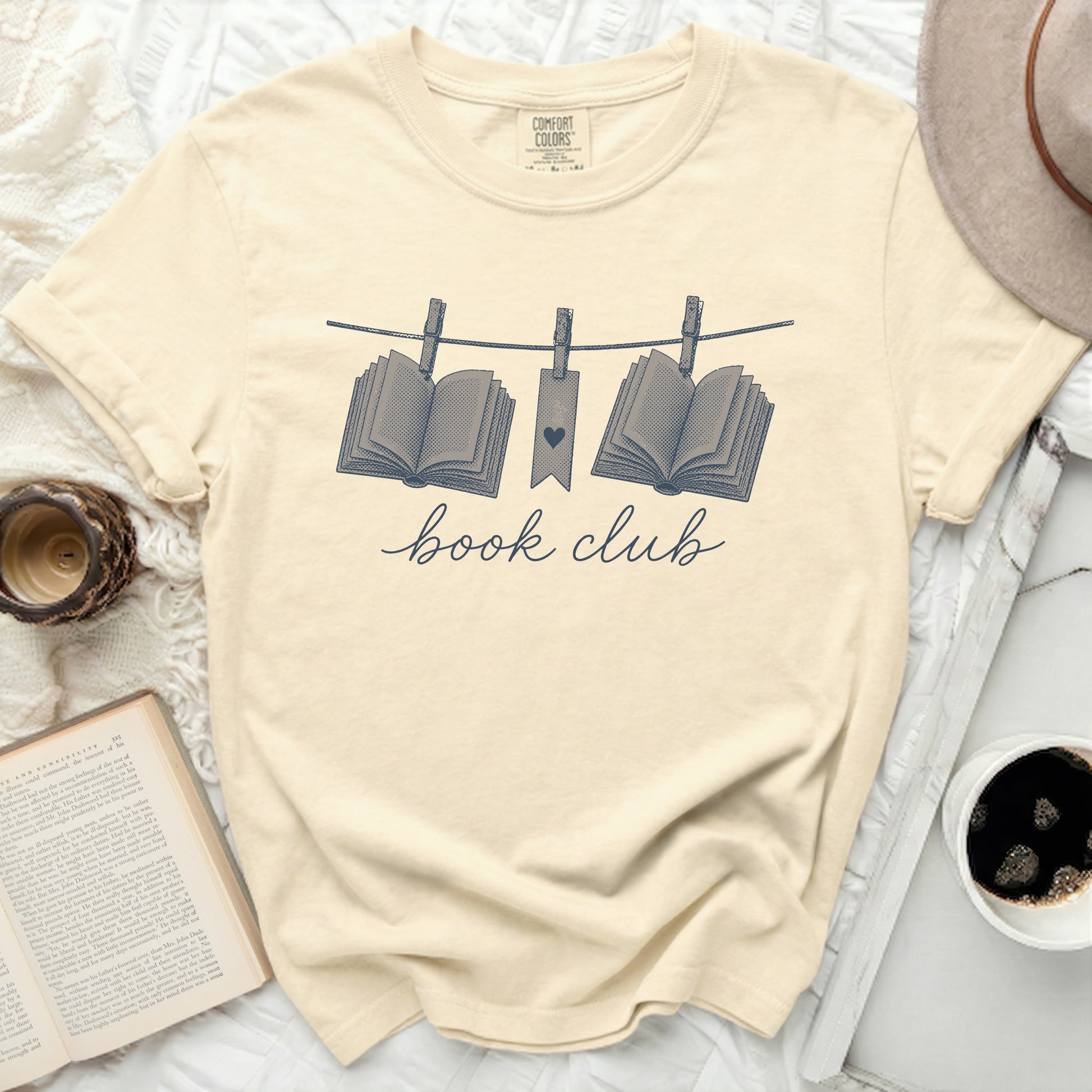 Cream t-shirt with "book club" text and open books graphic.