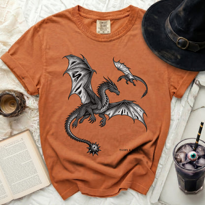 Orange t-shirt with black dragons graphic and "TAIRN & SGAEYL" text.