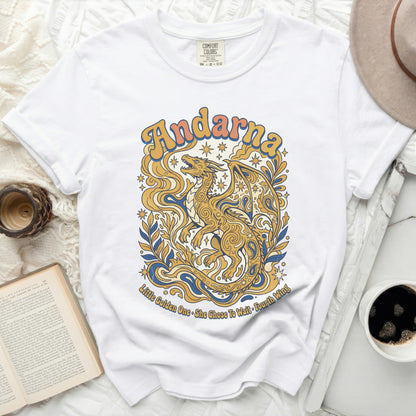 White t-shirt with gold dragon and text "Andarna" and "Little Golden One".