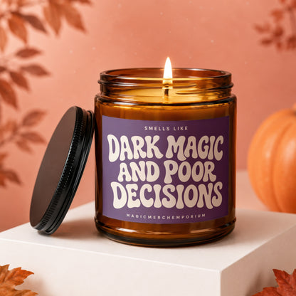 Amber jar candle with lit flame, reads "Smells Like Dark Magic and Poor Decisions."