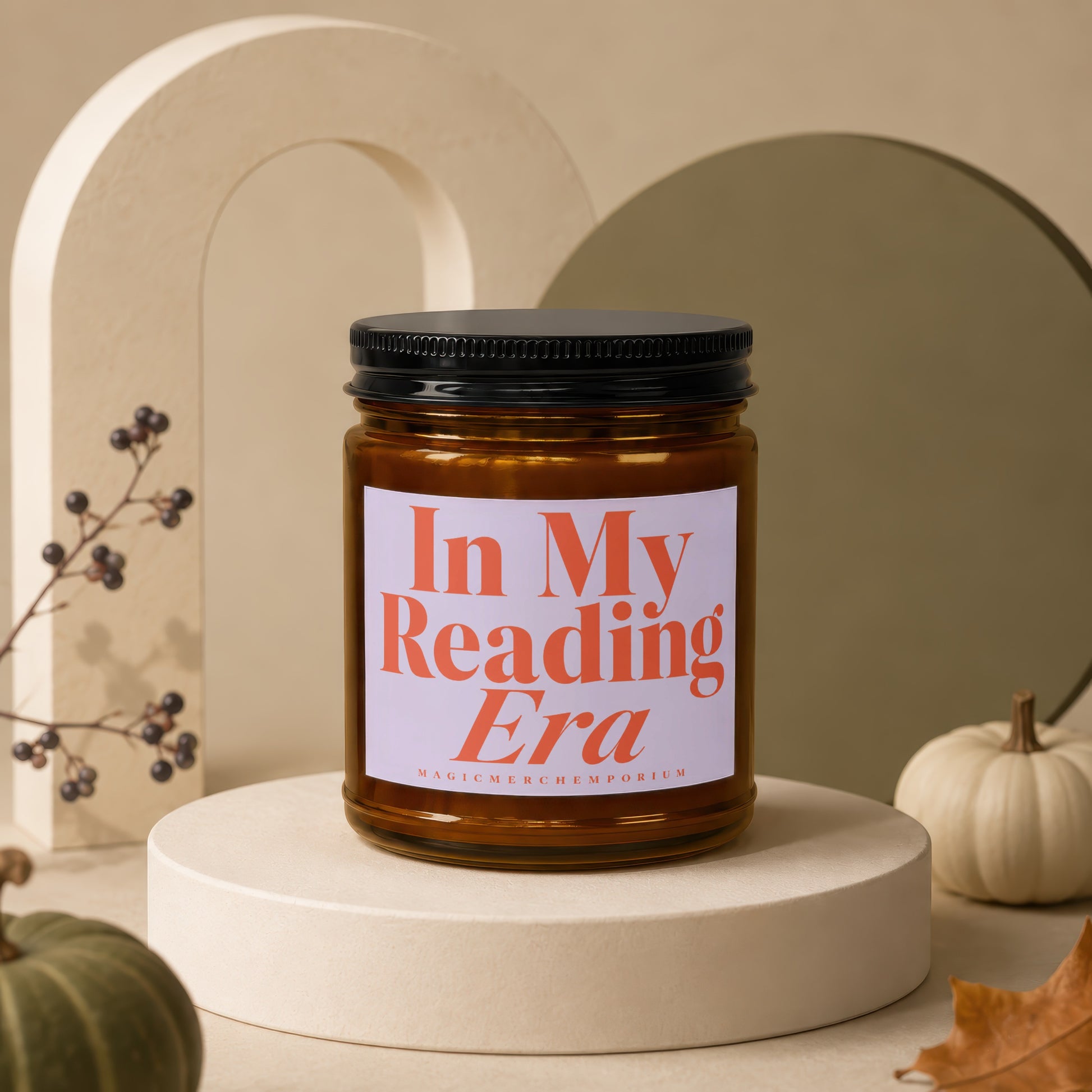 Amber jar candle with "In My Reading Era" text, on display with pumpkins and fall decor.