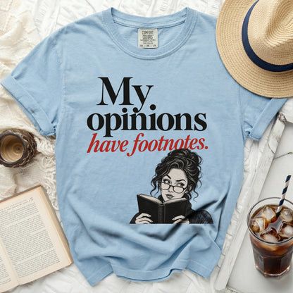 Light blue t-shirt with "My opinions have footnotes." text and illustration.
