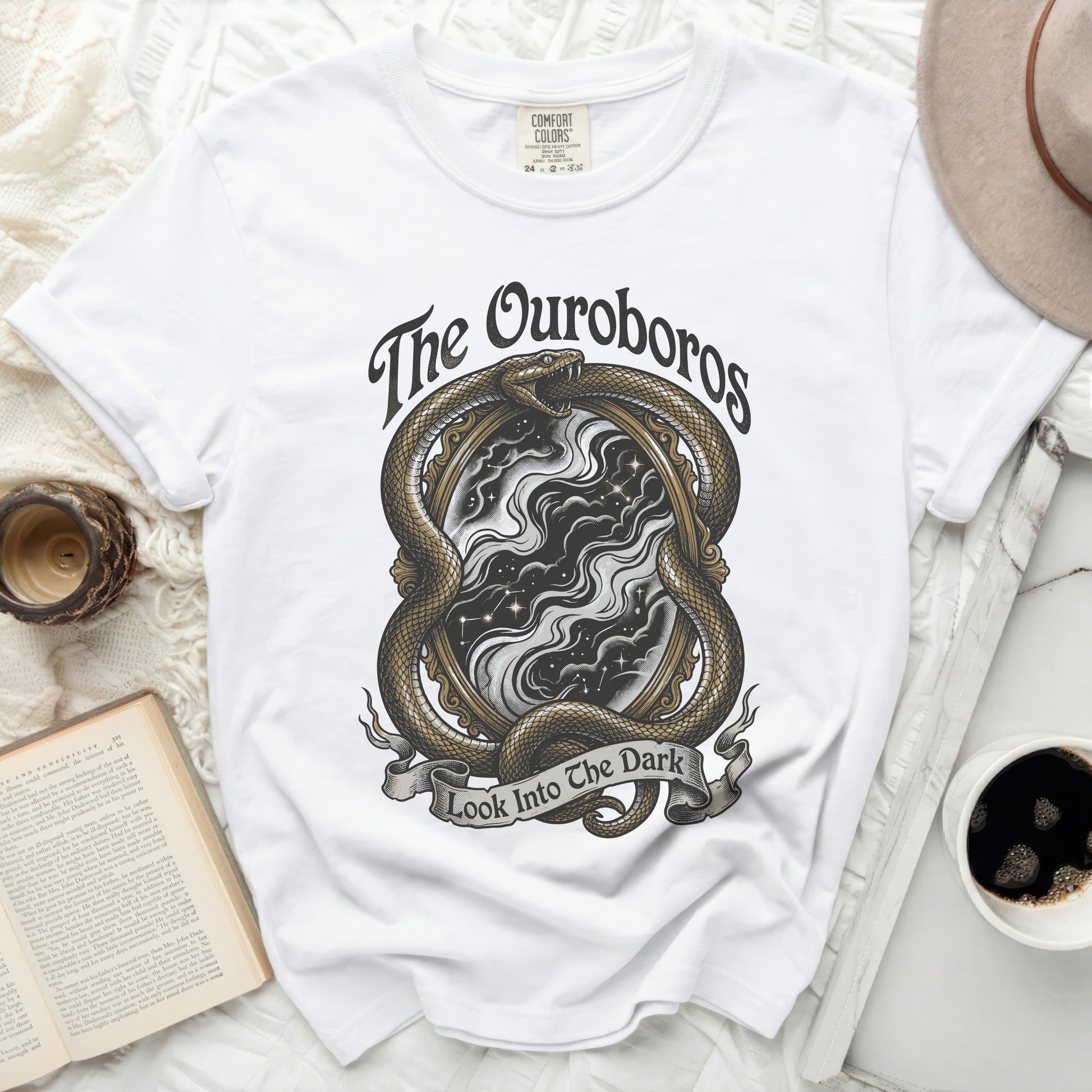 White t-shirt with Ouroboros snake encircling a starry void mirror, text "The Ouroboros Look Into The Dark".