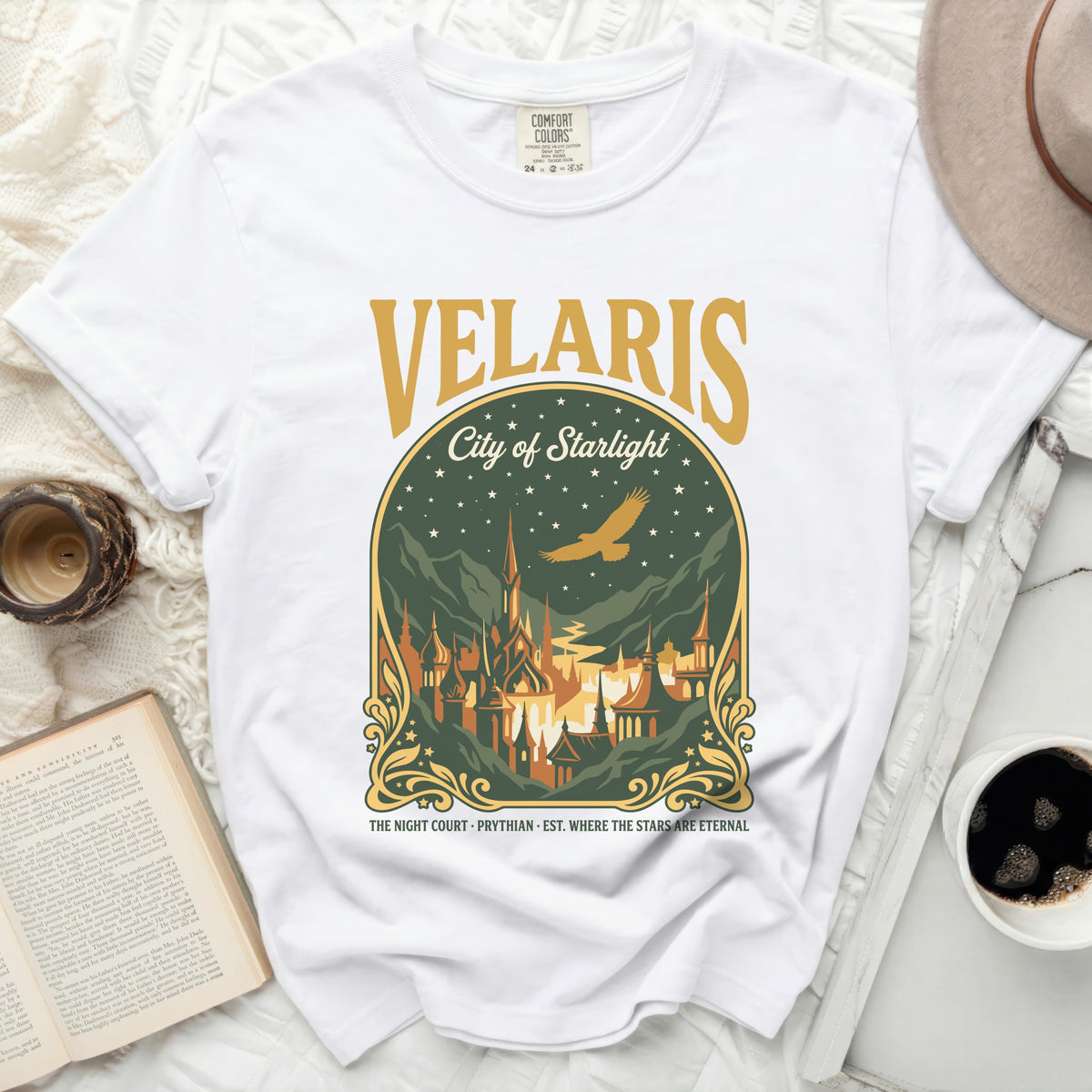White t-shirt with "Velaris City of Starlight" graphic and a city illustration.