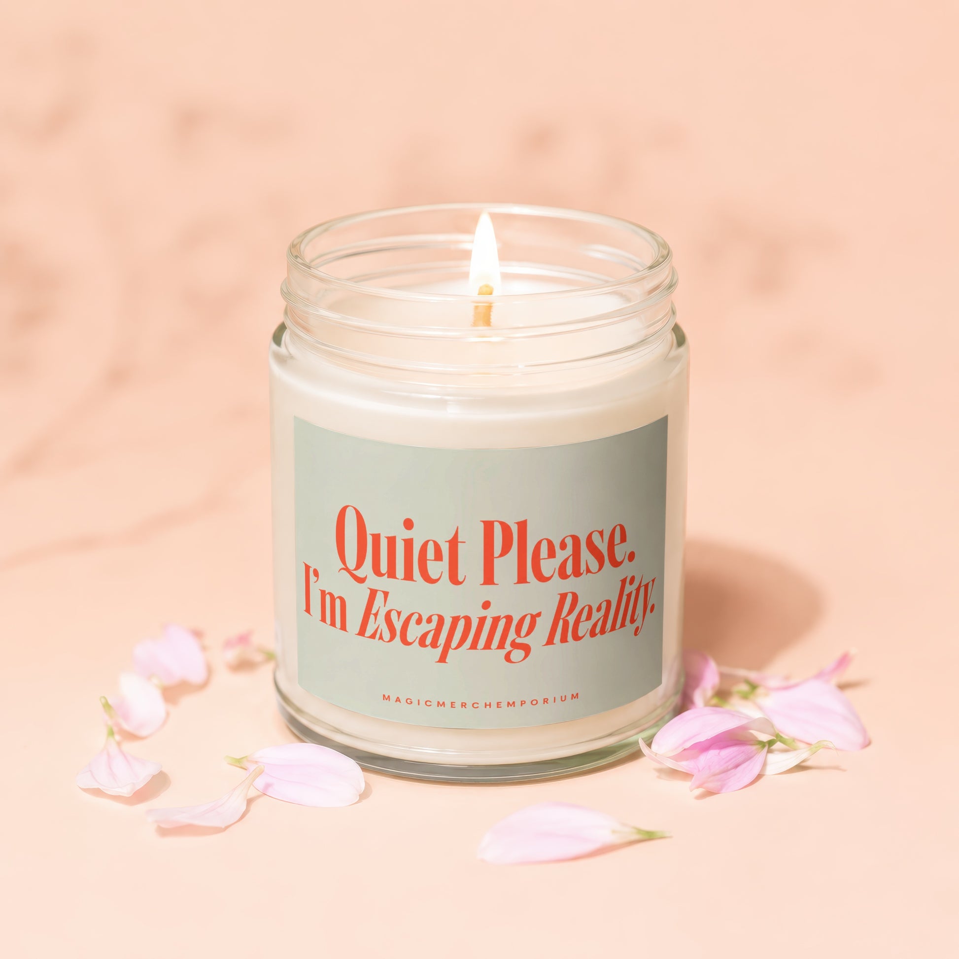 Jar candle with lit flame and "Quiet Please. I'm Escaping Reality" text.