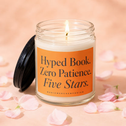 Jar candle with orange label reading: Hyped Book. Zero Patience. Five Stars.