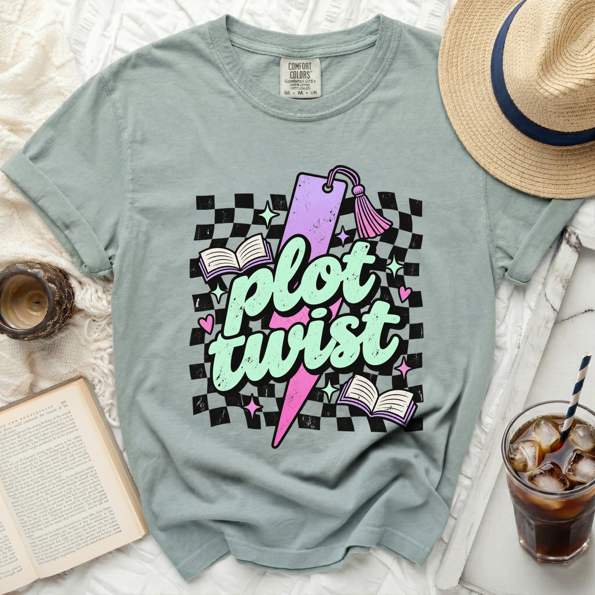 T-shirt with "plot twist" text, books, stars, and checkerboard pattern.