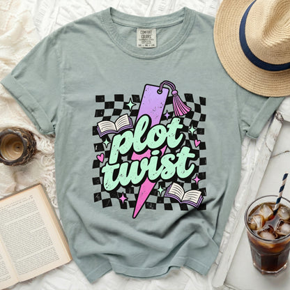 T-shirt with "plot twist" text, books, stars, and checkerboard pattern.