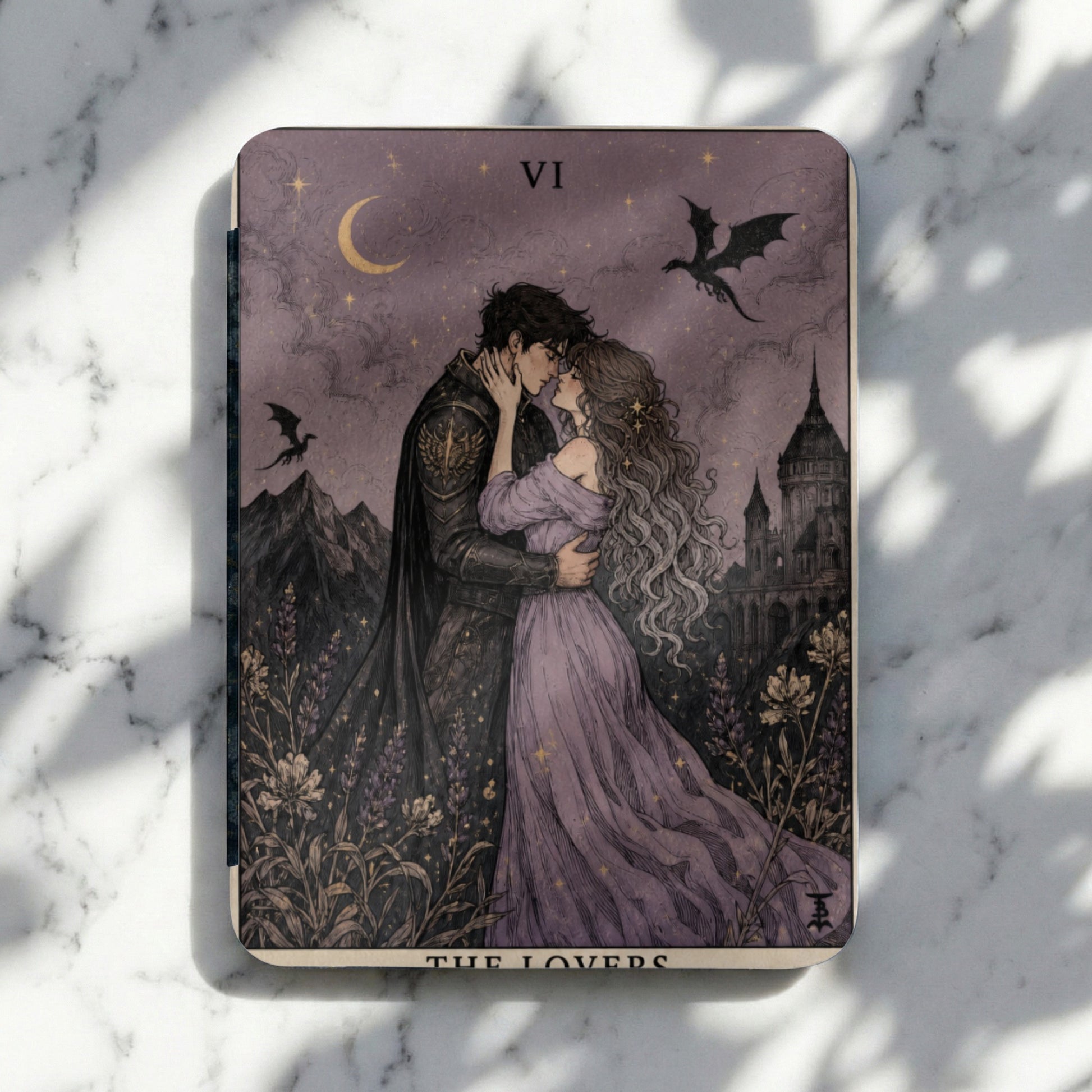Tarot card VI The Lovers depicts a couple embracing under a crescent moon with dragons and a castle.